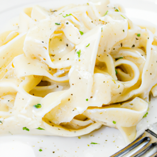 Creamy fettuccine alfredo garnished with parsley and cracked black pepper.